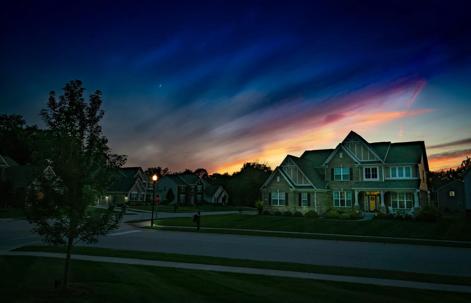 Same exterior property photo after AI night to daytime conversion with natural daylight before